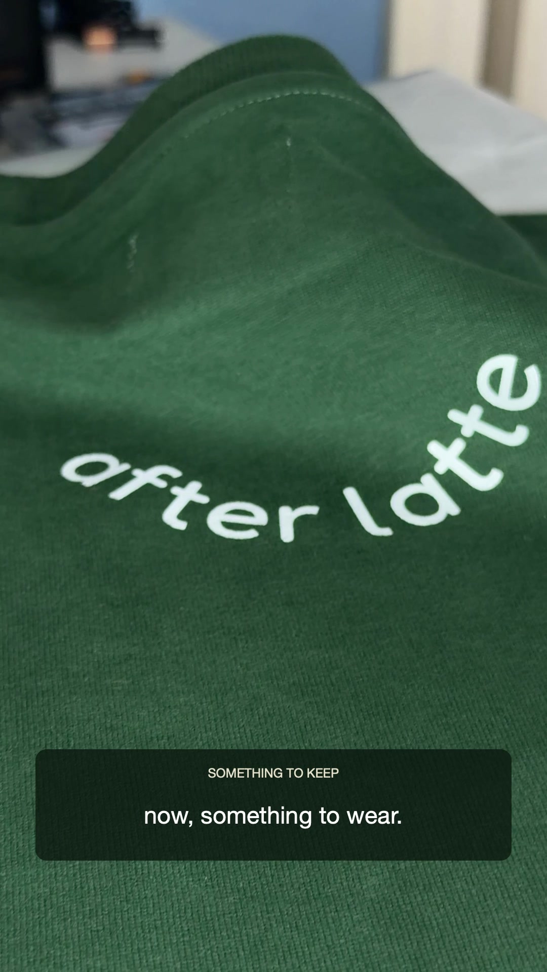 white after latte lettering on a green T-shirt, from the Day Three film